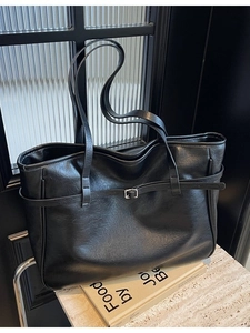 Minimalist large black leather tote bag with silver buckle strap for daily commute