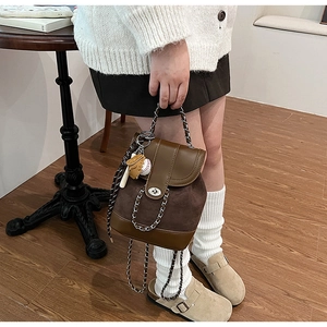 Detailed view of vintage frosted chain backpack with a creative baseball charm pendant