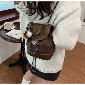 Detail of vintage matte mini backpack with chain strap and baseball charm pendant