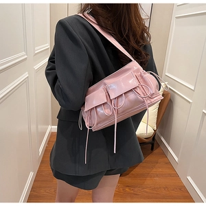 Pink glossy patent leather baguette bag with multiple pockets and drawstring detail