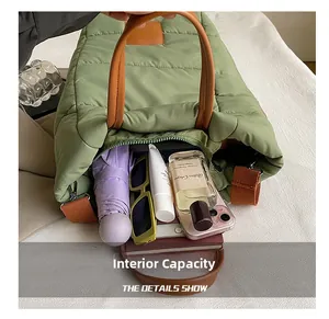 Internal capacity of sage green quilted bucket bag showing umbrella and phone storage