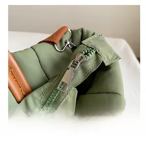 Detailed macro view of smooth silver metal zipper on green quilted bucket bag