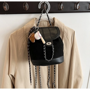 Detail of black frosted mini backpack with chain strap and baseball glove pendant decoration