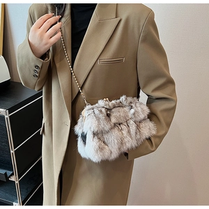 Détail du sac à bandoulière en fausse fourrure pelucheuse avec chaîne dorée sur mannequin