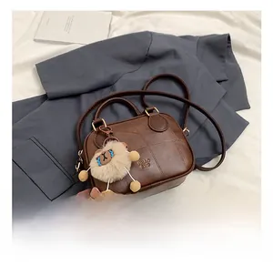 Brown vintage PU leather handbag with stitching detail and plush sheep charm on blazer