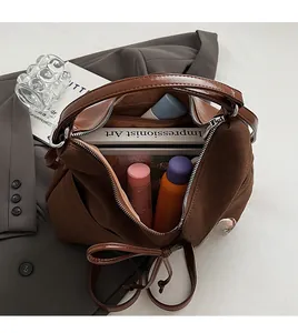 Spacious interior of brown vintage tote bag showing large capacity for books and cosmetics