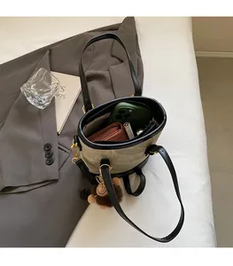 Detail shot of canvas bucket bag interior showing spacious storage for phone and wallet