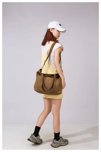 Full view of large dark brown canvas tote bag with adjustable strap and dual handles