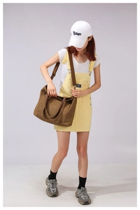Close-up of vintage brown canvas tote bag with adjustable strap and large front pocket