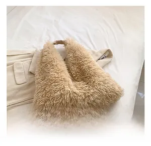 Detail showing the fluffy texture and plush faux fur material of the brown handbag