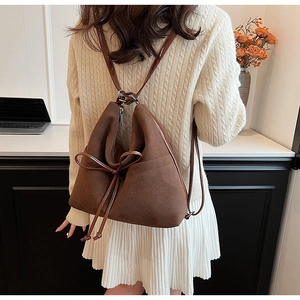 Detail of a vintage dark brown matte tote showing the textured finish and shoulder fit