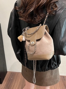 Fashionable brown suede and leather bucket backpack with chain strap and metal lock
