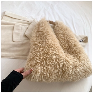 Detail of soft faux fur texture on a light brown plush tote bag for autumn winter