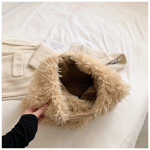 Detailed interior view of the beige faux fur tote bag showing the lining and spacious capacity