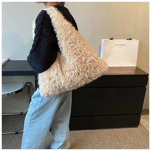 Detailed close-up of fluffy cream faux fur shoulder bag with soft plush texture