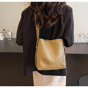 Détail montrant la texture tissée kaki et la forme seau de ce sac à bandoulière chic