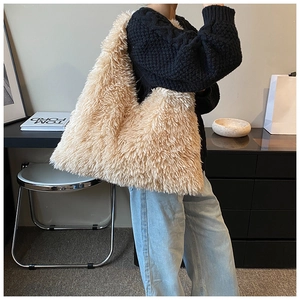Detailed close-up of large plush tote bag showing soft faux fur texture and wide strap