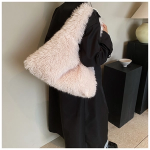 Close-up of a large fuzzy plush shoulder bag in soft pink faux fur material