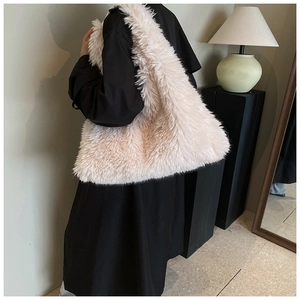 Detailed view of plush cream faux fur tote bag showing the soft texture and large capacity