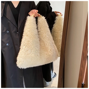 Chic beige plush tote bag shown with a black coat in a mirror-style reflection shot