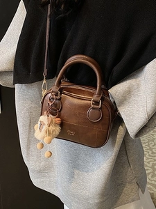 Retro dark brown Boston bag with textured leather and plush charm for women
