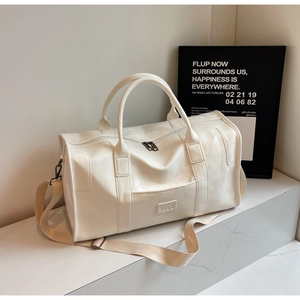 Detalle de bolsa de viaje blanca en cuero lichi con logo NOCO y doble cremallera