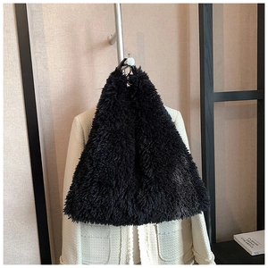 Detail shot of a black plush faux fur scarf on a hanger for winter fashion styling