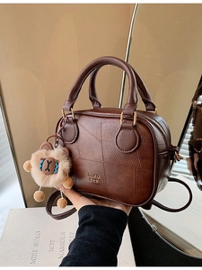 Retro brown leather Boston handbag for women with plush doll charm and mirror reflection