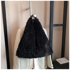 Detail of black faux fur tote bag showing plush texture and triangular silhouette