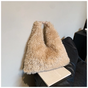 Macro shot of fluffy light camel plush fabric and leather wrapped handle on hobo bag