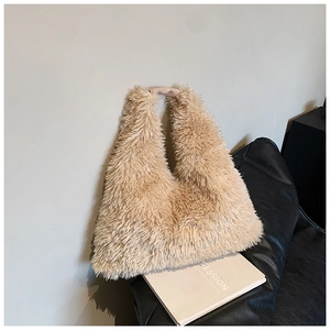 Detail of plush faux fur tote bag showing soft texture and contrast leather handles