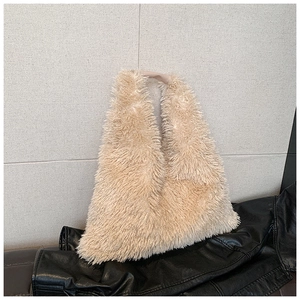 Detailed close-up of beige faux fur tote bag showing plush texture and leather handle