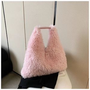 Close-up of pink faux fur texture and smooth leather handle on a large tote bag