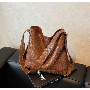 Détail du tissage marron et de la texture en cuir de ce sac hobo élégant pour femme