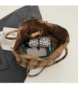 Spacious interior of canvas tote bag with zipper pocket holding phone, umbrella, and wallet