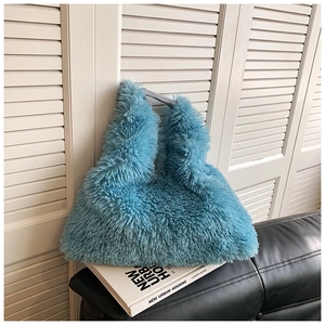 Macro shot of fluffy blue faux fur texture on a winter tote bag with soft plush fiber details