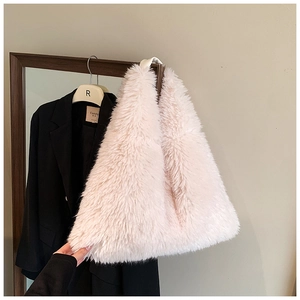 Detailed view of soft light pink faux fur tote bag with fluffy long-haired texture