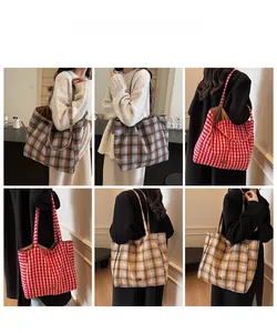 Detail showing various plaid tote bags in red, blue, and yellow with long shoulder straps