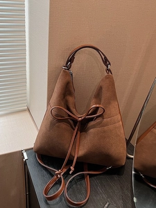 Vintage brown frosted leather tote bag with a bow tie detail and trapezoid shape