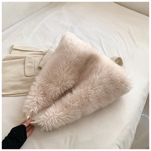 Detailed close-up of fluffy cream plush tote bag texture with integrated wide shoulder strap