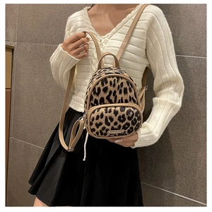 Leopard print plush backpack on model with metallic Fashion Bags brand detail