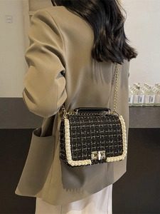 Women's black tweed crossbody bag with pearl trim and gold chain shoulder strap