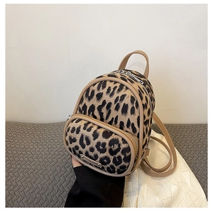 Close-up of leopard print mini backpack with plush fabric and PU leather straps