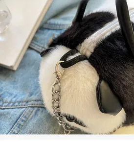 Close-up of soft plush panda bag with silver chain strap and faux leather handle