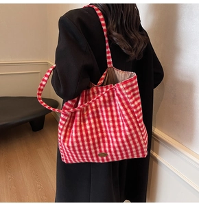 Detail view of large red and white checkered faux fur tote bag with long shoulder straps