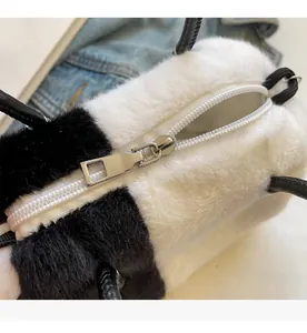 Macro detail of high-quality smooth zipper and fluffy faux fur texture on panda bag