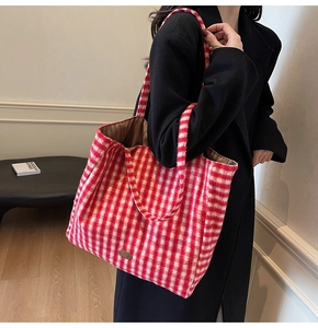 Detail of red and white plaid tote bag showing its soft wool texture and large capacity