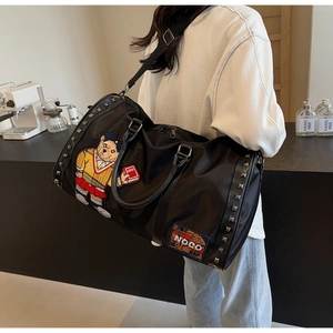 Detail of black large travel bag with cartoon bear embroidery and side metal rivets