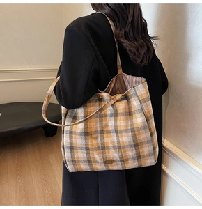 Detail of checkered autumn tote bag showing wool fabric texture and metal logo