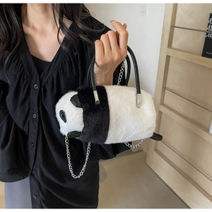 Detail of plush panda cross-body bag with soft faux fur texture and silver chain strap